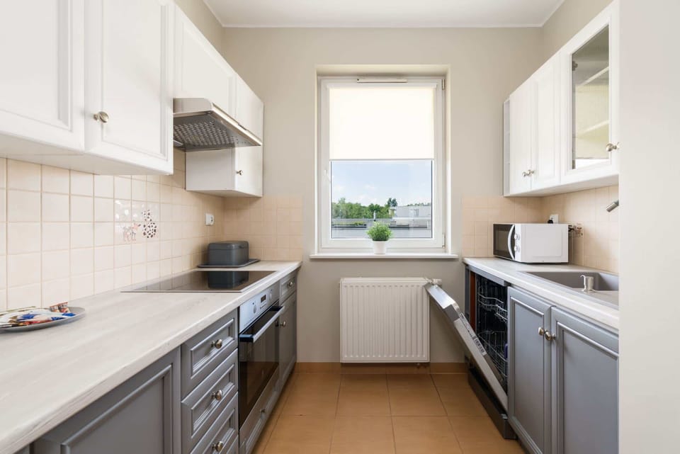 Kitchen with plenty of kitchen utensils and dishes. 