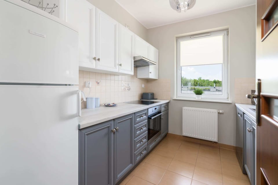 Kitchen with oven and refrigerator. 