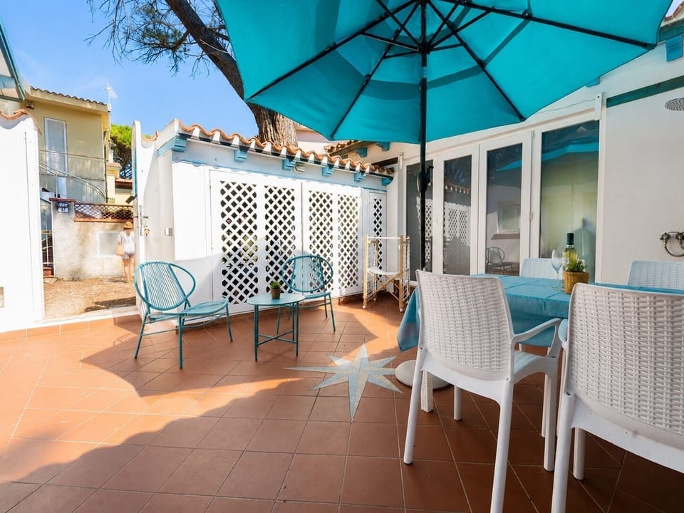 Sunny private patio with shaded dining and cozy outdoor seating
