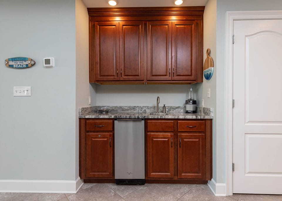 Mix up refreshing drinks at the sleek wet bar, adding fun to your beachside getaway experience