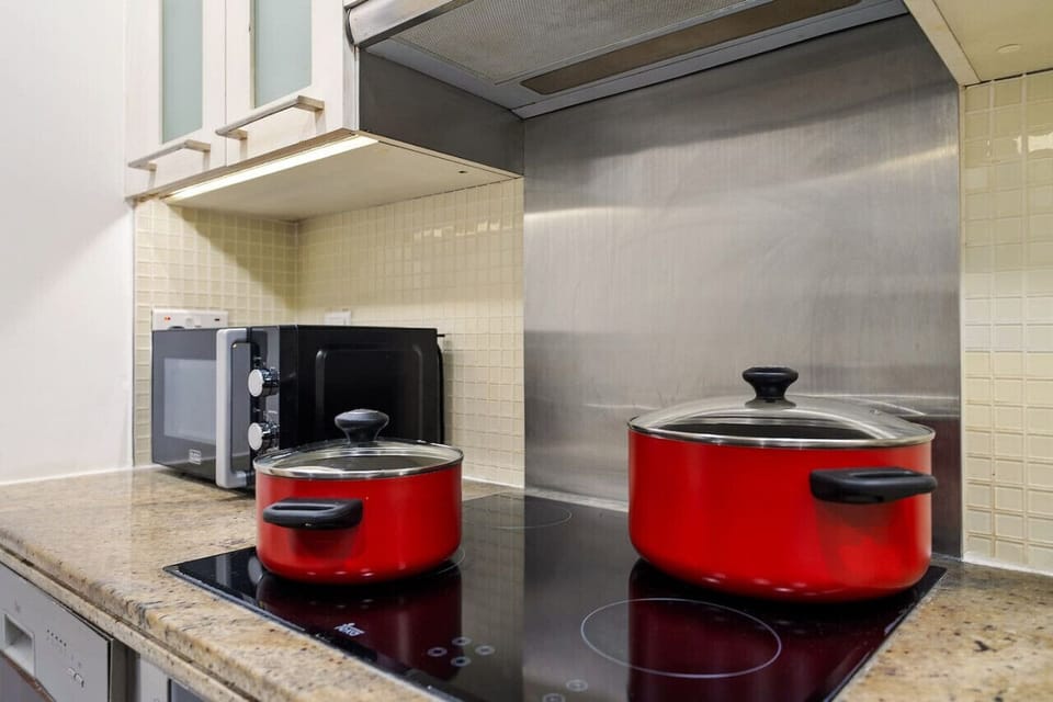 Kitchen: Cook up a storm with modern appliances and vibrant cookware in style!