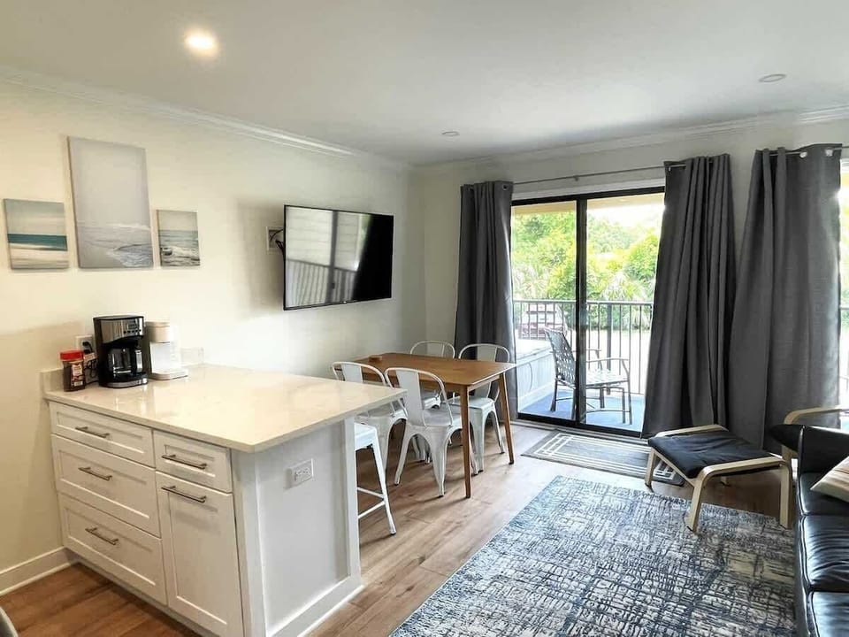 Our open-concept living space has modern coastal decor and a large flat-screen TV.