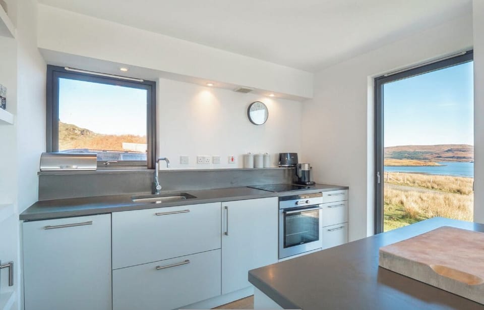 Kitchen with hob and sink and island with more views