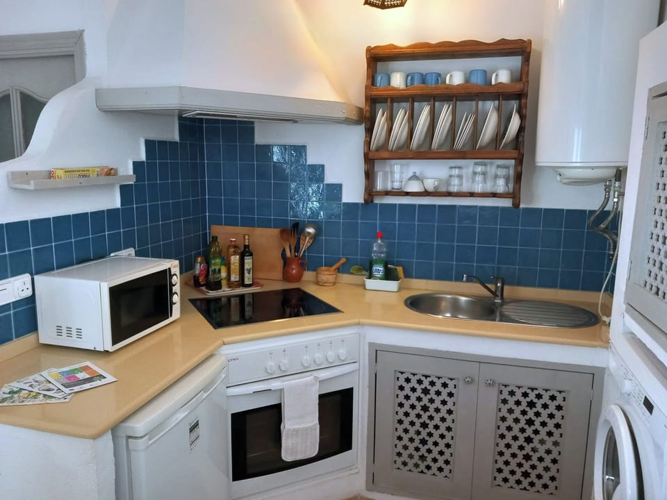 The kitchen has electric hob, oven, fridge freezer, microwave, kettle & toaster