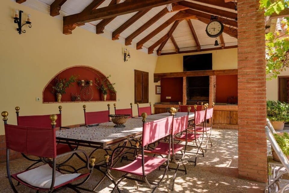 Outside, there is a large table for 10 people next to the barbecue. (1)