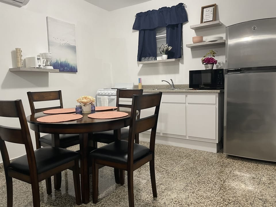 dining and kitchen with kitchen essentials and toaster, coffemaker, microwave