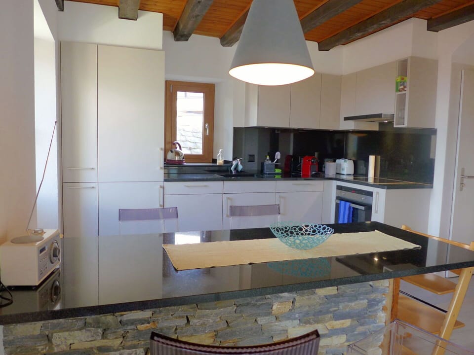 Cabinetry, Countertop, Property, Kitchen, Kitchen Appliance, Wood, Kitchen Stove, Interior Design, Lighting, Building