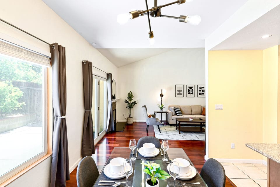 Dining area. Modern glass table and Sputnik chandelier. Lots of natural light
