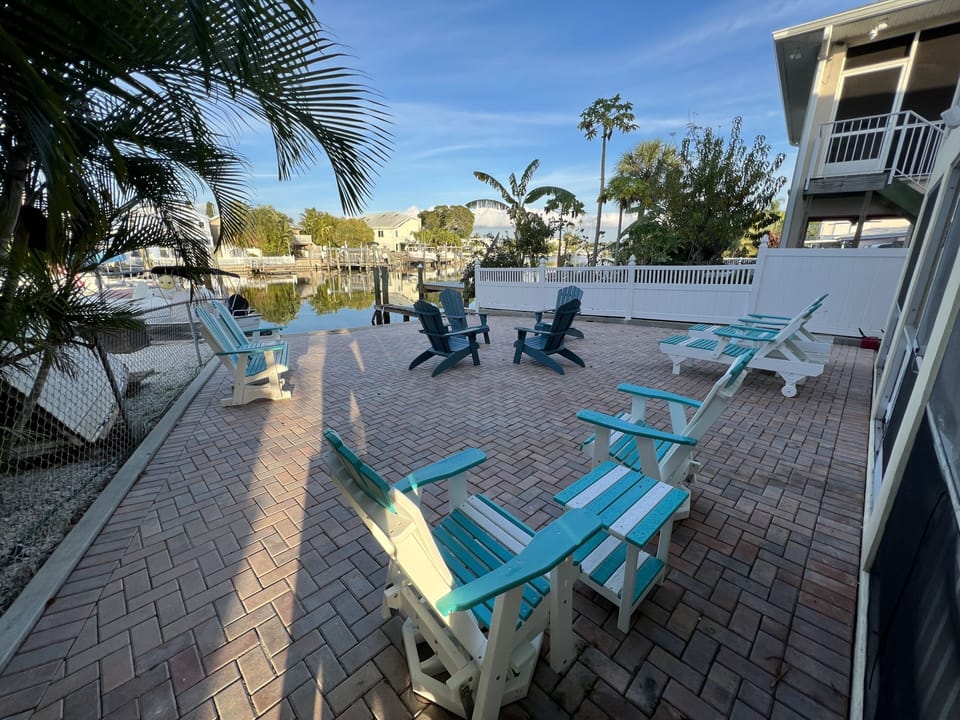 Shared waterfront backyard area with grill and plenty of seating