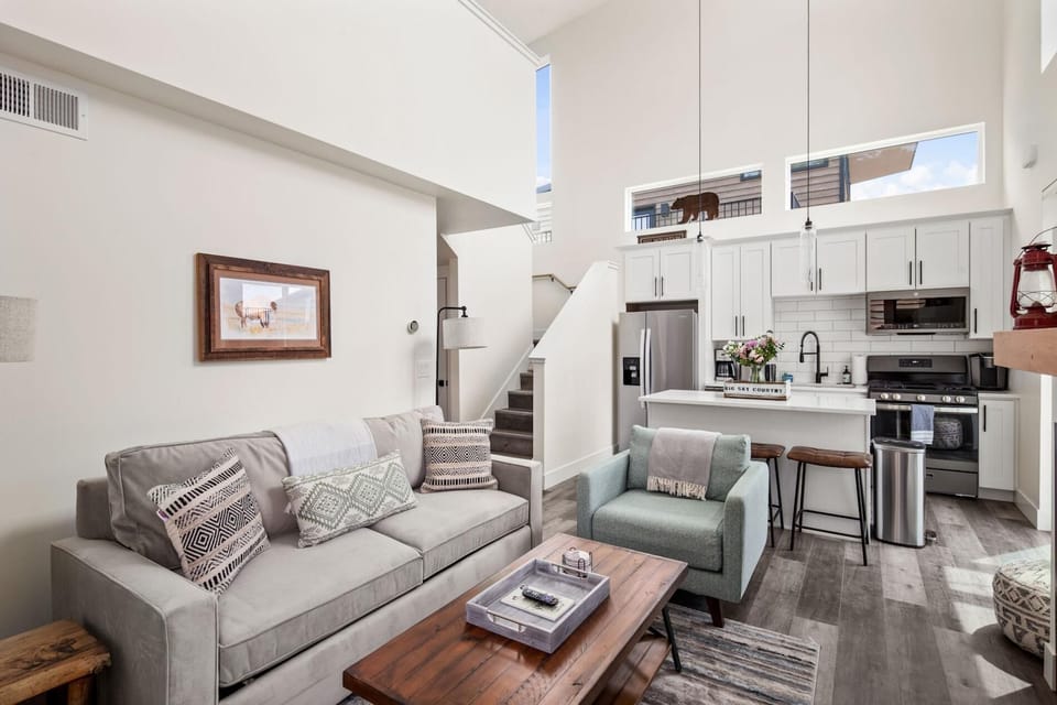 The living room features a luxury memory foam queen size pullout, large HDTV with streaming capabilities, gas fireplace, and vaulted ceilings.