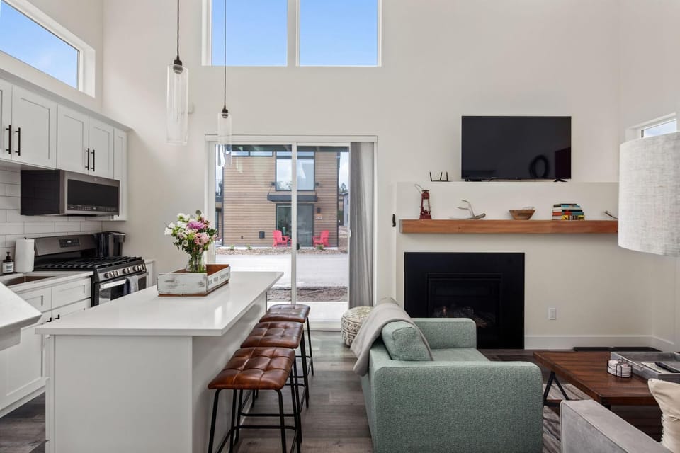 Main living space with open concept living room and kitchen and walkout to a patio.