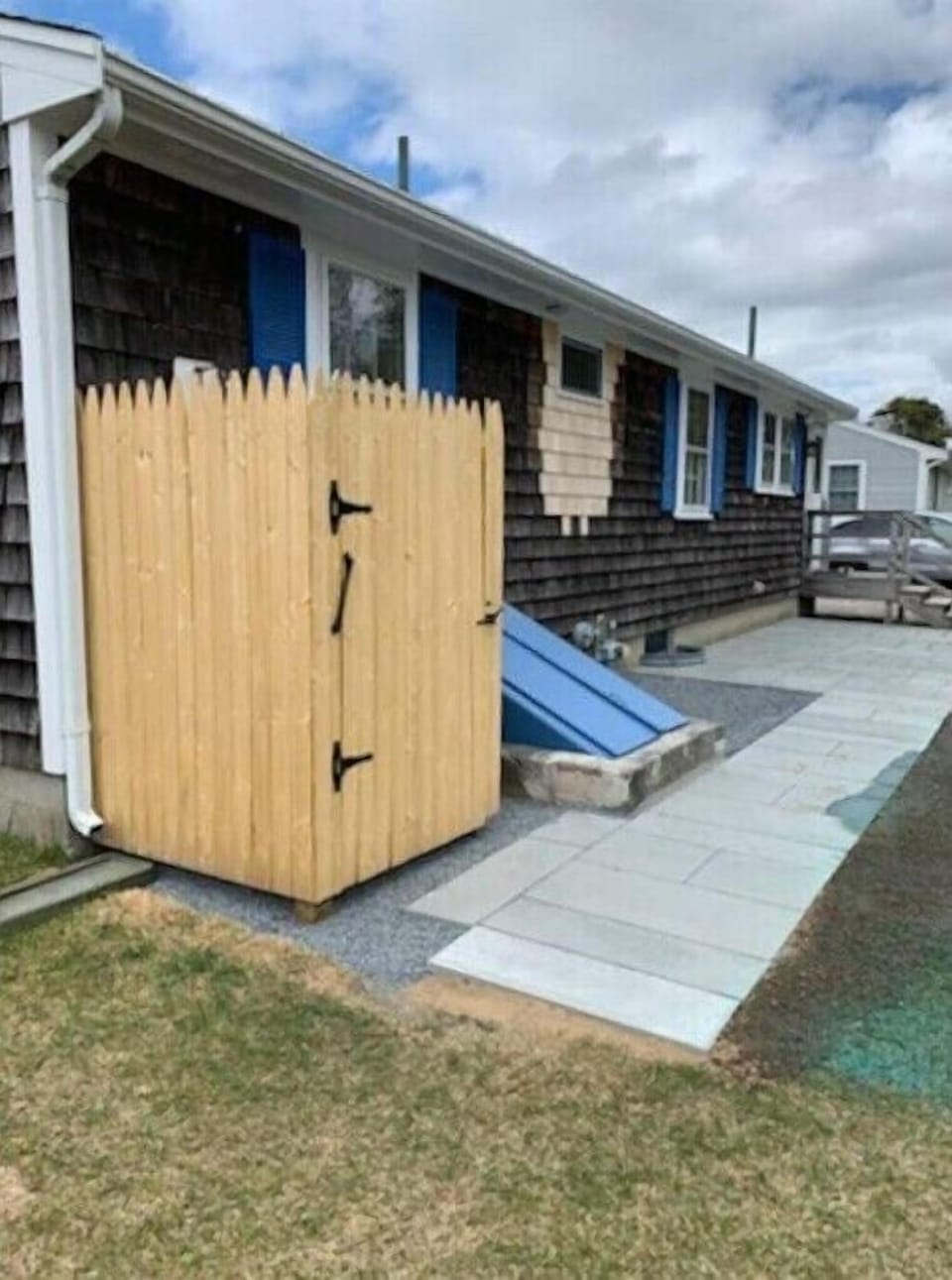 Enclosed outdoor shower with towel hooks. Shampoo, conditioner and soap provided