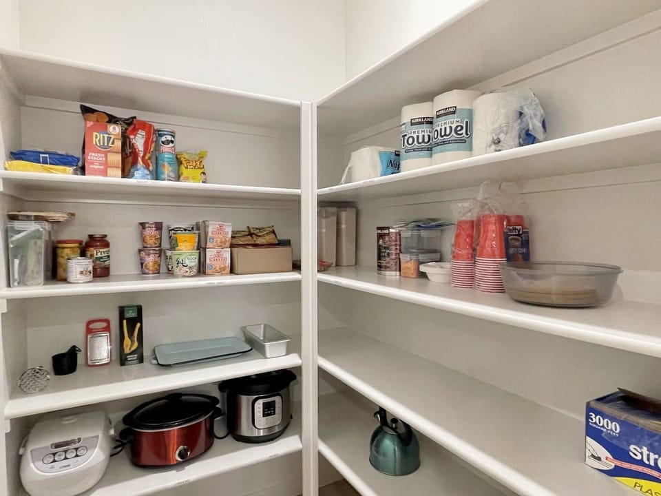 Pantry with extra towels, rice cooker, crock pot, and instapot