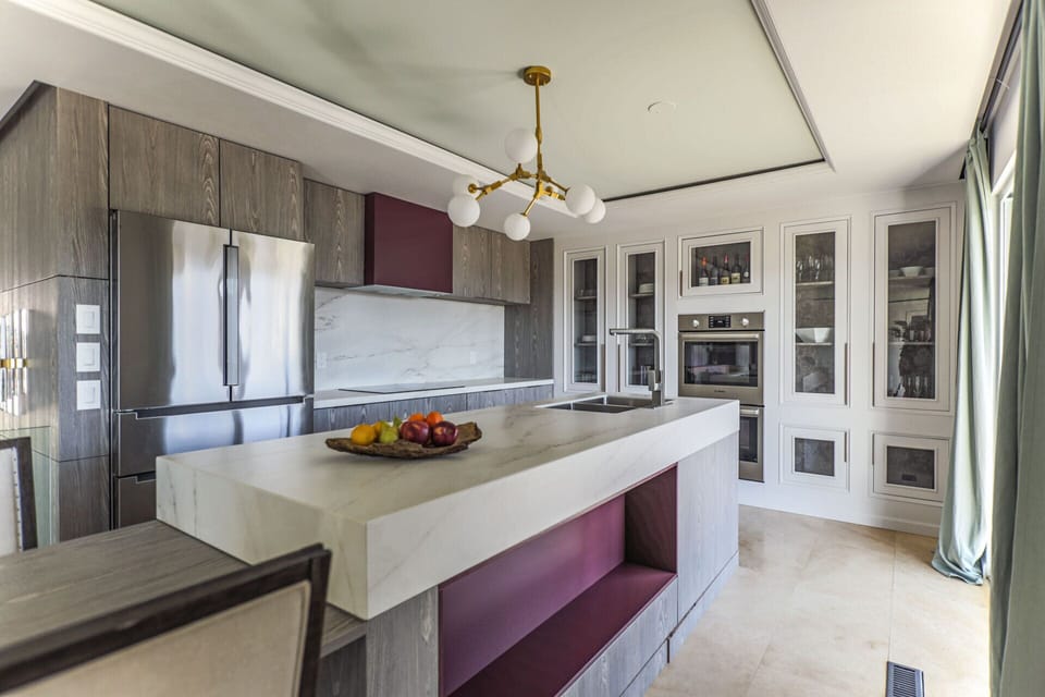 Kitchen with double oven, microwave, induction stove, fridge, dishwasher, hood