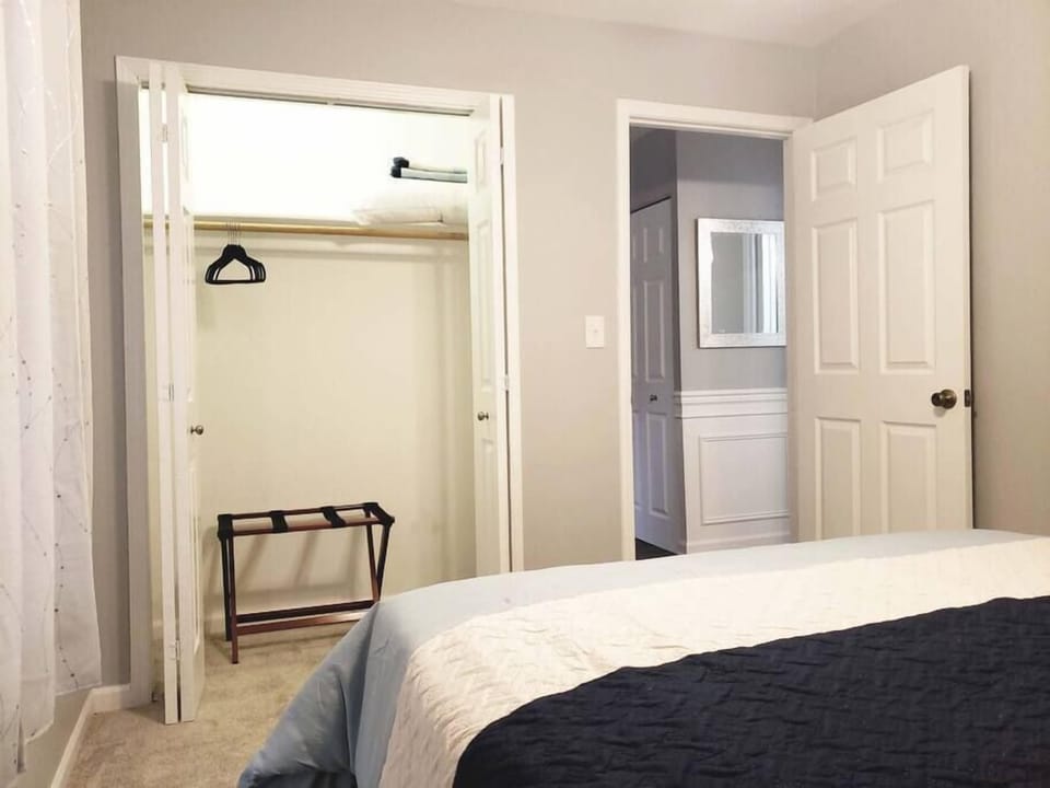 Closet space in both bedrooms include a luggage stand, hangers, a shelf and an extra pillow 