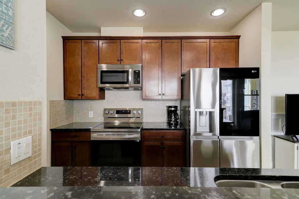 Galley kitchen is open to dining area and looks out towards the Gulf of Mexico.