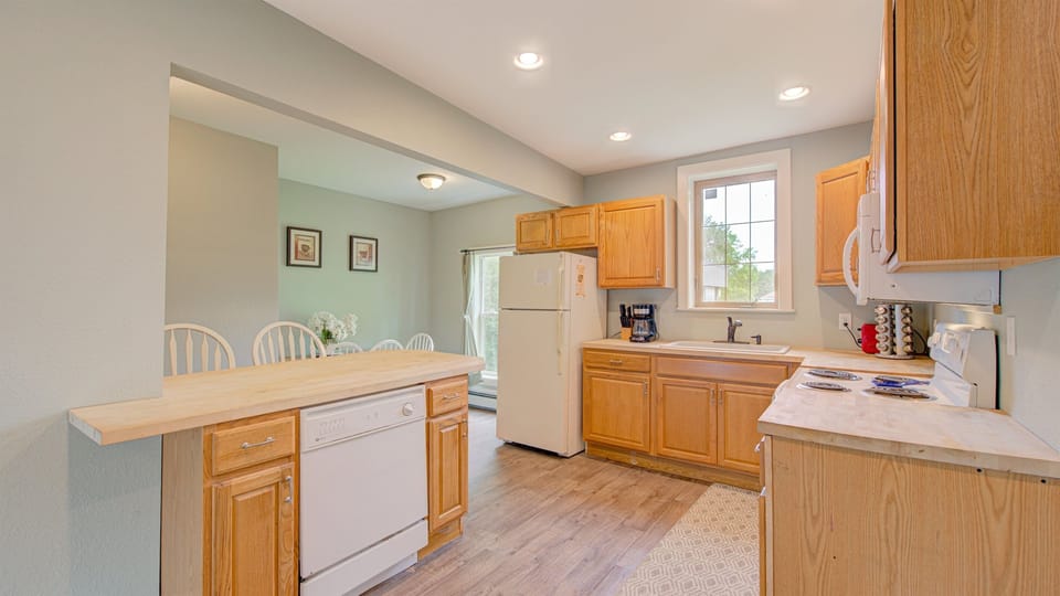 The warm, sunny kitchen has a dishwasher, microwave, fridge and stove for your cooking convenience. 