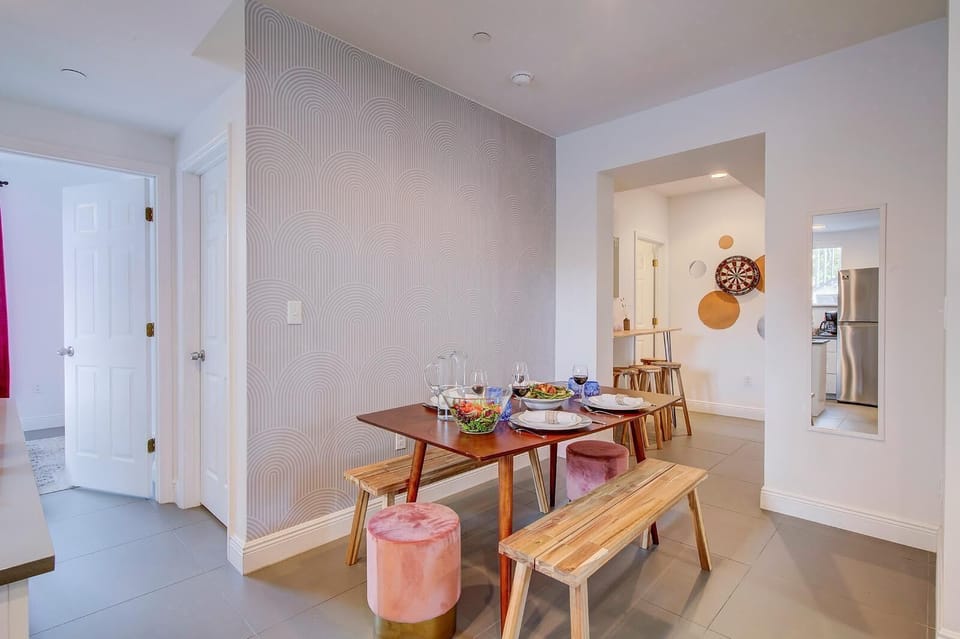 Dining room and wall mounted table at the back. First bedroom to the left. 