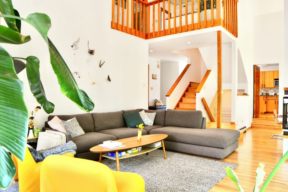 Main living room area filled with natural light connected to outdoor spaces. 