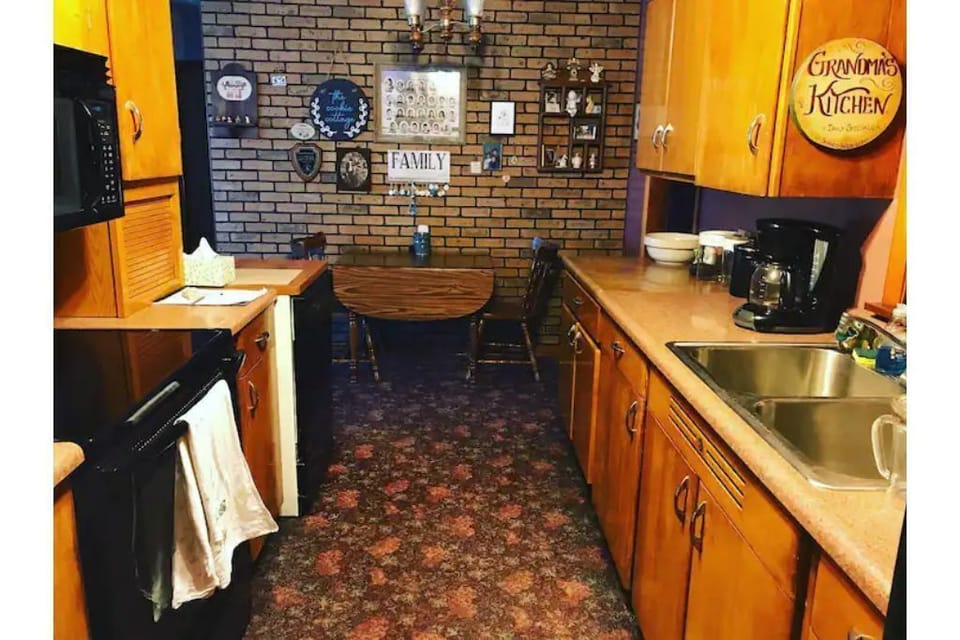 Galley Kitchen, stocked with appliances, utensils, plates, etc. for cooking.