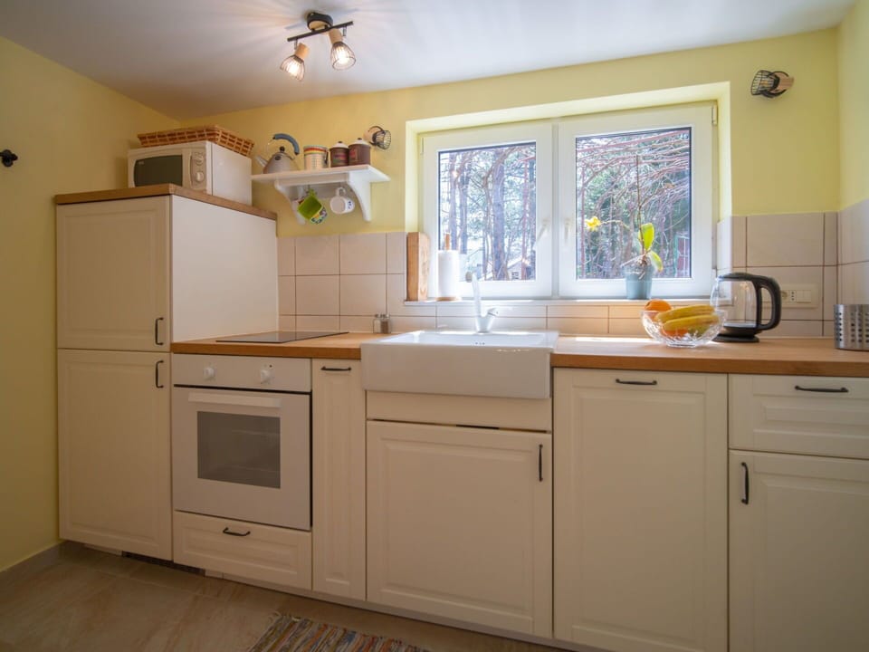 Cabinetry, Property, Kitchen Sink, Countertop, Wood, Kitchen, Sink, Kitchen Appliance, Lighting, Interior Design