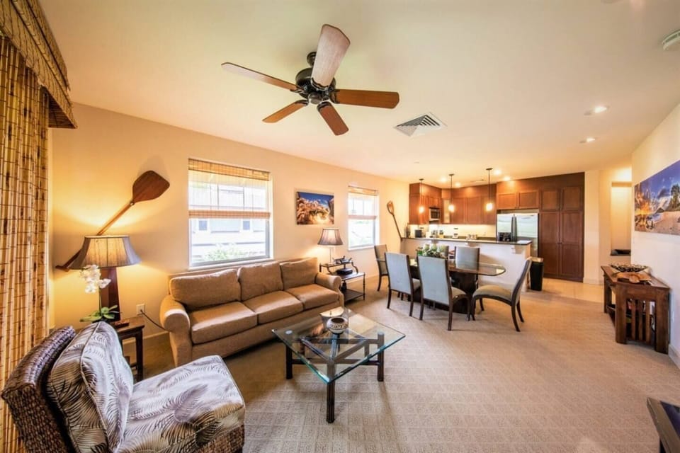 The large living room has a pullout queen-size bed that sleeps two comfortably. Sliding doors lead to the lanai with golf course views. 