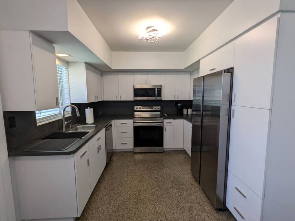 A nice modern feel from the fully equipped and furnished kitchen with all the major stainless steel appliances and small appliances needed to make your stay enjoyable. Coffee station with Keurig, French press, and tea.