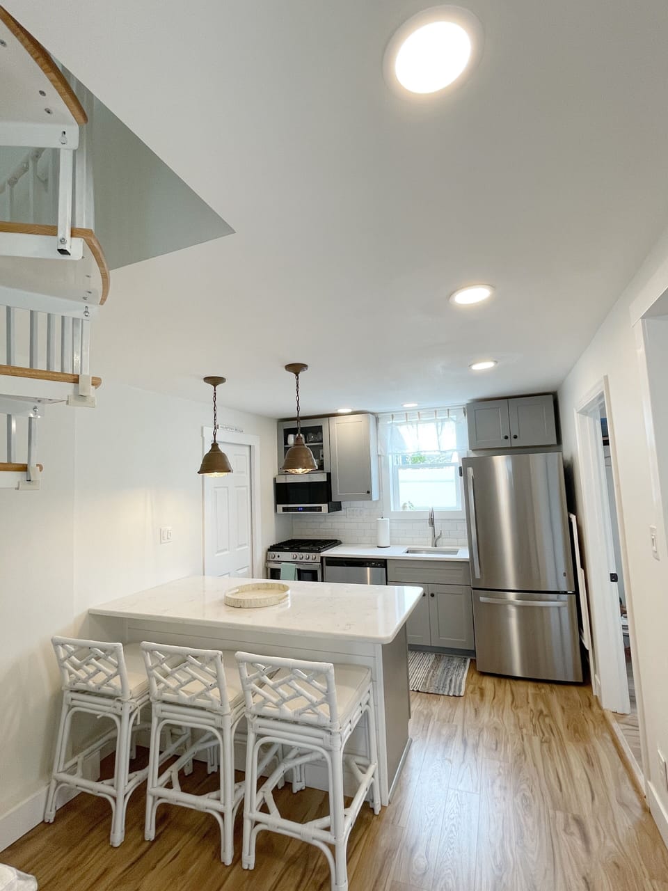 Kitchen area with spiral staircase to go upstairs