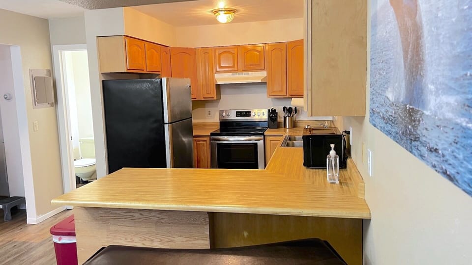 Full kitchen stocked with plenty of dishes and cookware