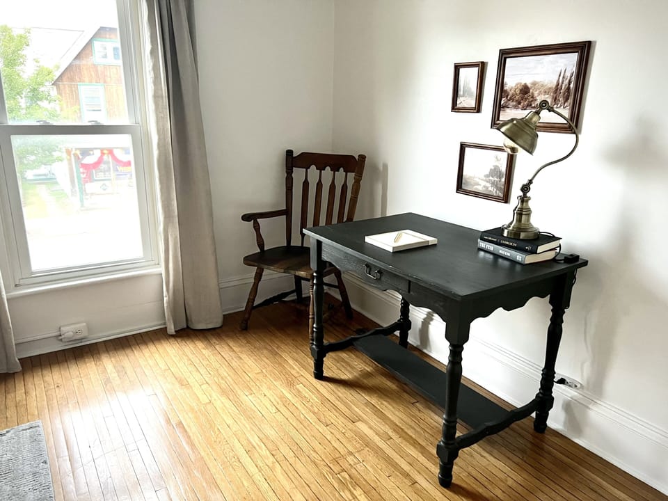 Very well lit work space near a window with street view.
