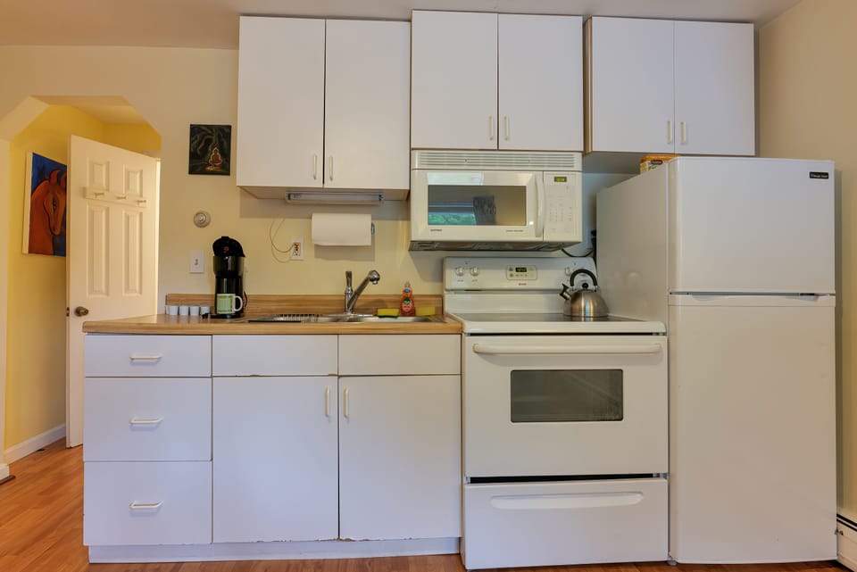 Kitchen with Full sized Refrigerator, Microwave, and Coffee Maker. 