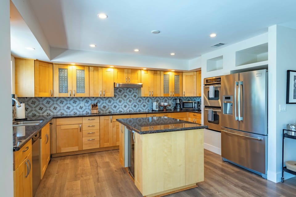 Your gourmet kitchen awaits with professional-grade appliances, custom cabinetry, stunning granite counters, and stylish tile backsplash. A spacious island invites you to prep meals or gather with friends.