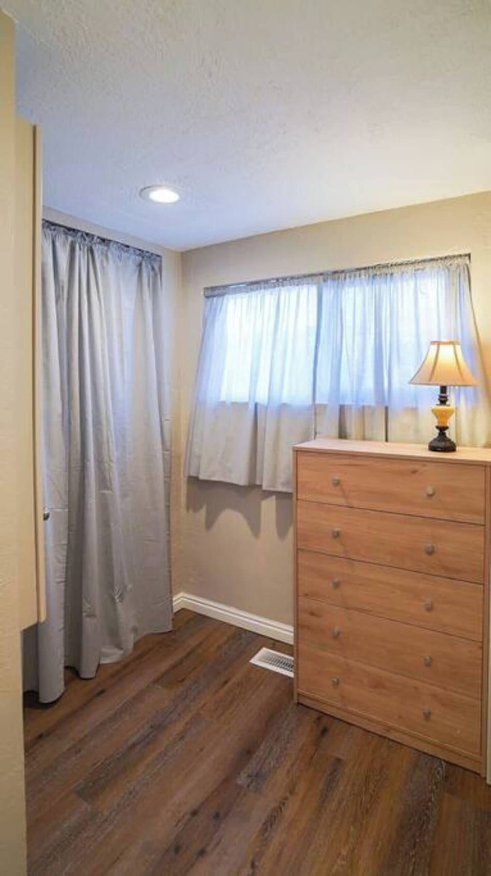 Big walk-in closet with plenty of drawer and hanging space; wall ironing board