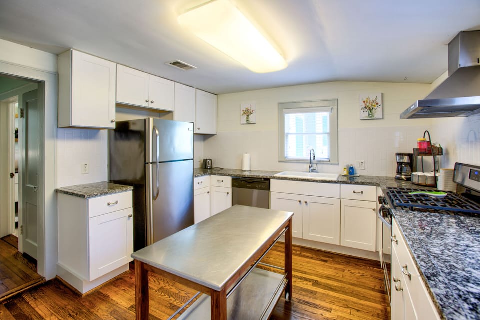 Kitchen w/ refrigerator, oven, microwave, toaster, coffee maker, dishwasher.