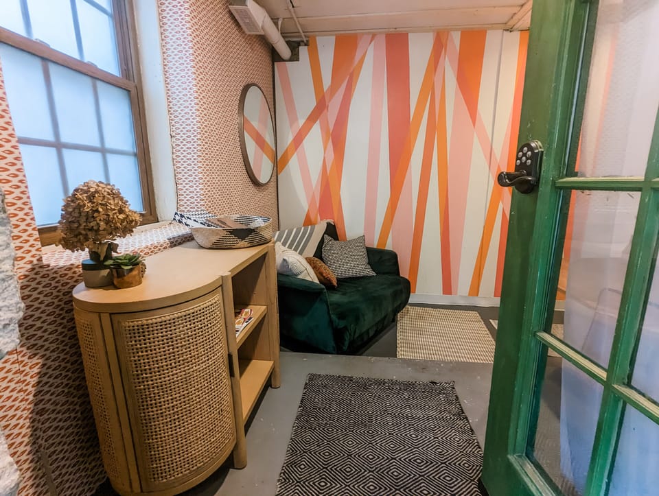 Colorful and bright entry area. Doubles as a seating area and workspace.