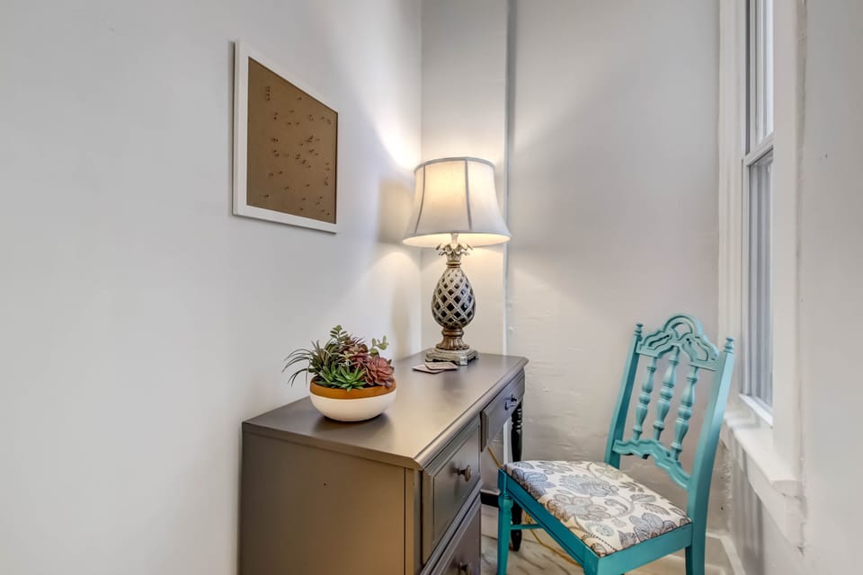 The home has a small office with a desk and chair off the kitchen.