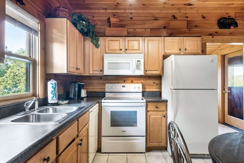 The fully stocked kitchen looks out beyond to the great outdoors!