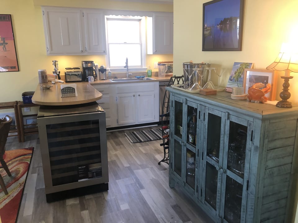 Beverage cooler and bar area to minimize traffic behind the stove.
