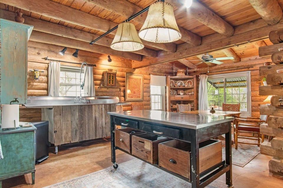 Modern kitchen touches like the industrial sink stand side-by-side with rustic reminders of yesteryear.