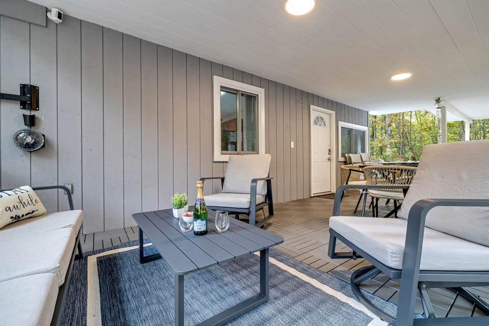 Unwind at the cozy outdoor table on the covered deck, perfect for enjoying a meal or morning coffee.