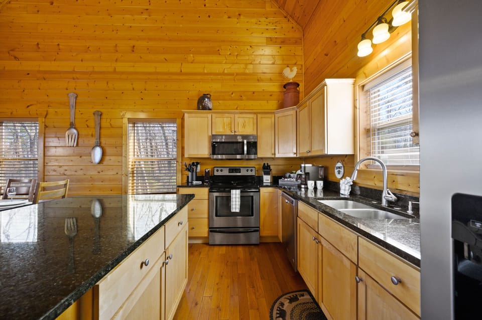 Full kitchen with modern appliances and cooking supplies