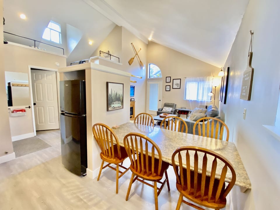 Open concept kitchen, living and dining rooms w/ vaulted ceilings and two lofts