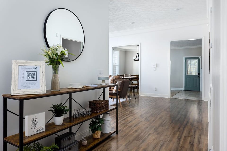 Stylish entry table with tasteful decor with glimpse into the living room