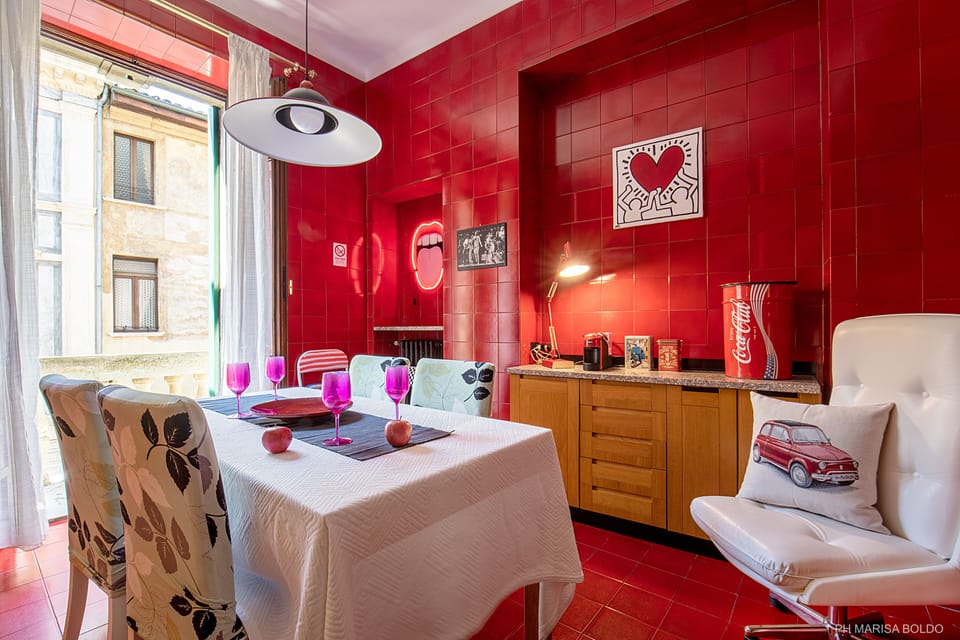 Dinning area with hand-crafted Venetian Red tiles and a balcony, ph Marisa Boldo