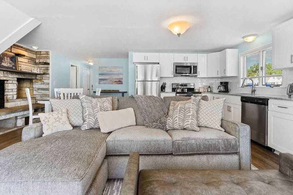 Living room with sleeper sofa, 50" smart TV, high-efficiency mini-split for AC/heat, and stunning views of the ocean.