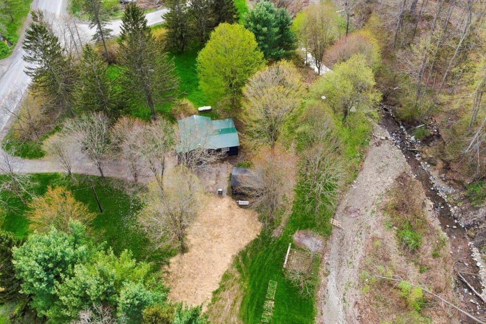 Embrace the panoramic beauty of the Finger Lakes from this unique vantage point; our rental offers an expansive property with a creek, surrounded by nature's undisturbed tranquility.