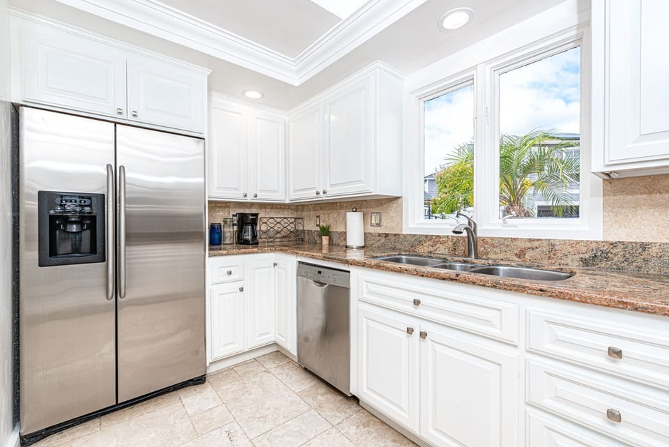 The kitchen looks out onto the quiet neighborhood street.
                