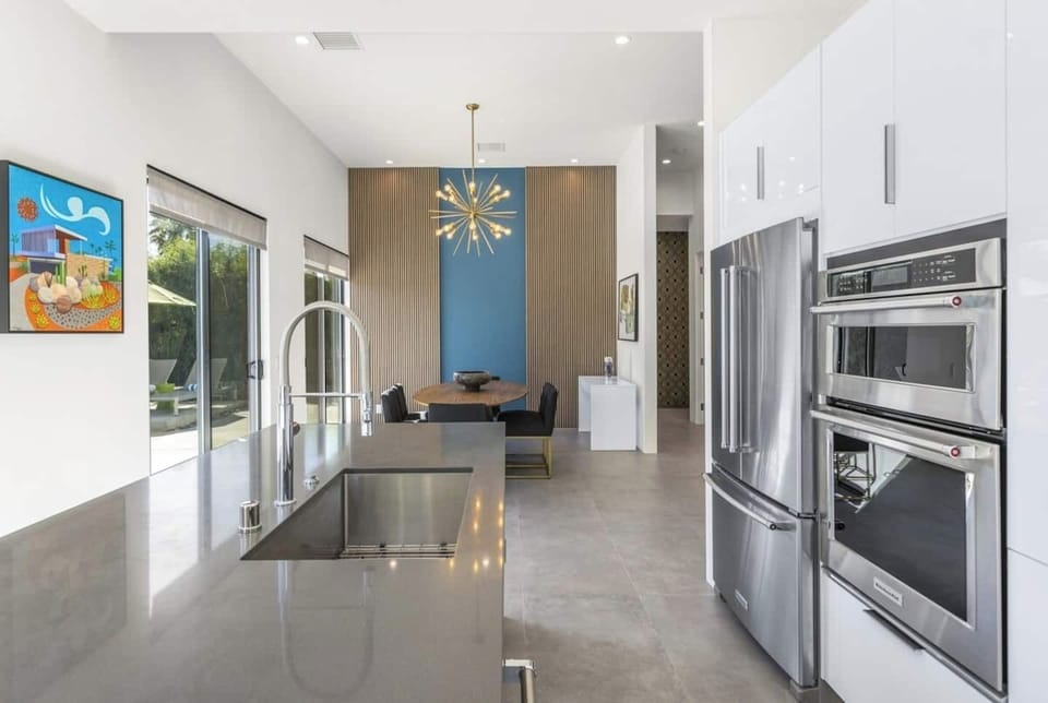 Chef’s kitchen with sleek stainless appliances and open dining area for effortless entertaining.