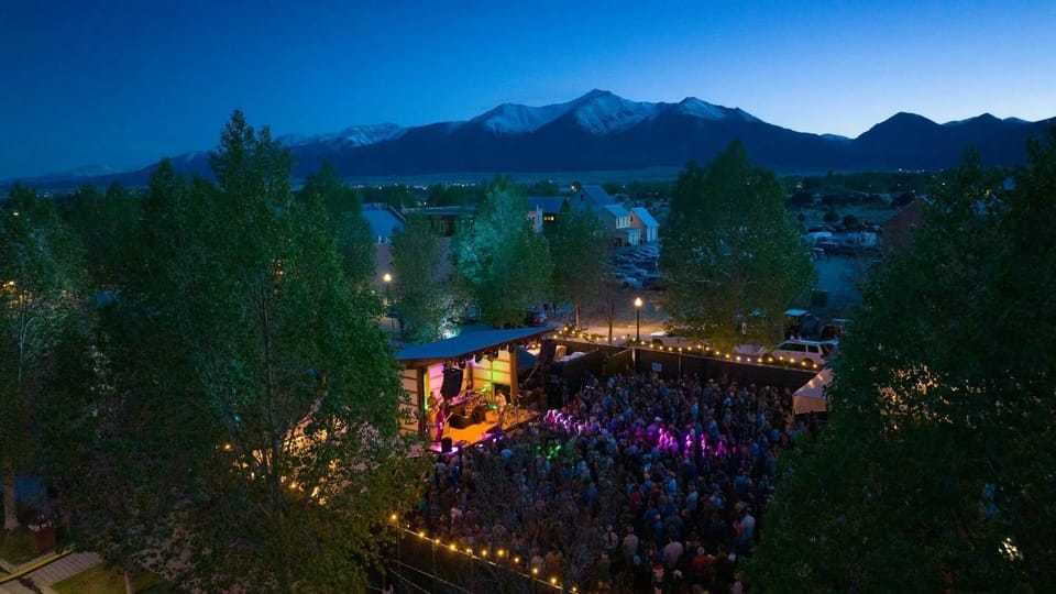 Live music and community gatherings at South Main Town Square with mountain views in the background