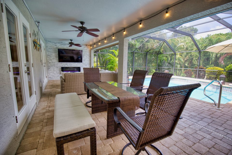 Spacious lanai with sofa and dining area under cover with seating for 7.